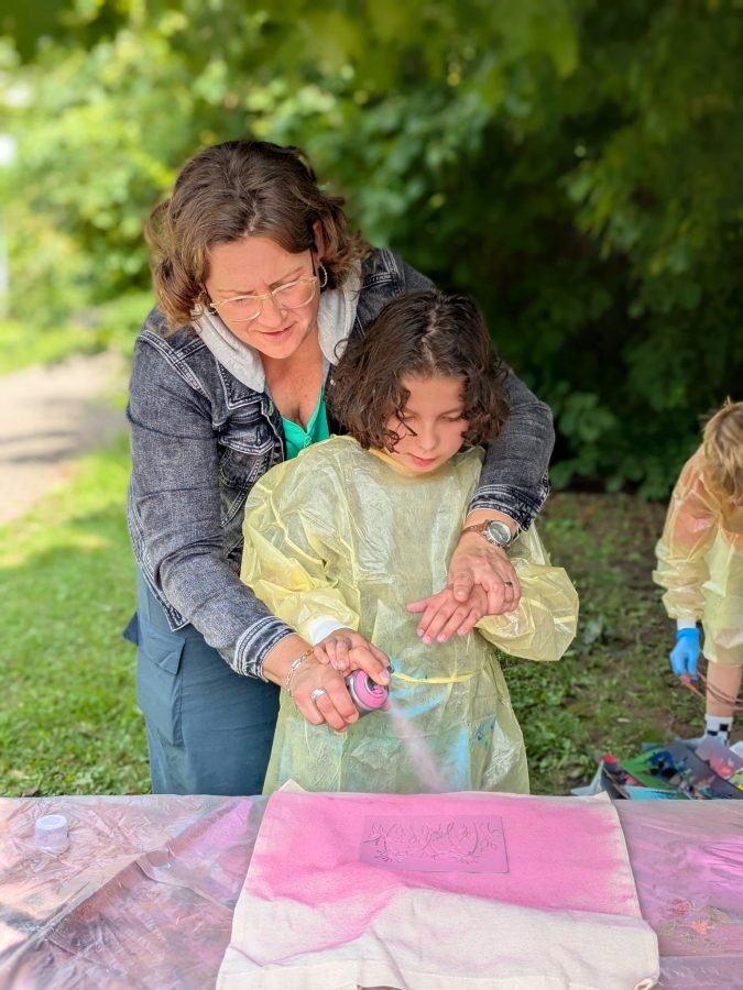 Kind und Betreuerin am Sprühen